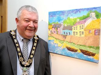 Mayor Ivor Wilson with artwork from the exhibition