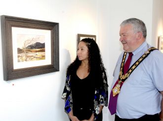 The Mayor of Causeway Coast and Glens Borough Council Councillor Ivor Wallace and Arts and Cultural Facilities Officer Esther Alleyne view a beautiful piece currently on display in Jim Holmes’ new exhibition at Roe Valley Arts and Cultural Centre.